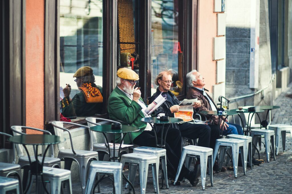 Europeans drink coffee at an outdoor cafe